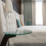 A stylish and cozy modern bedroom featuring elegant decor and soft lighting, perfect for relaxation.